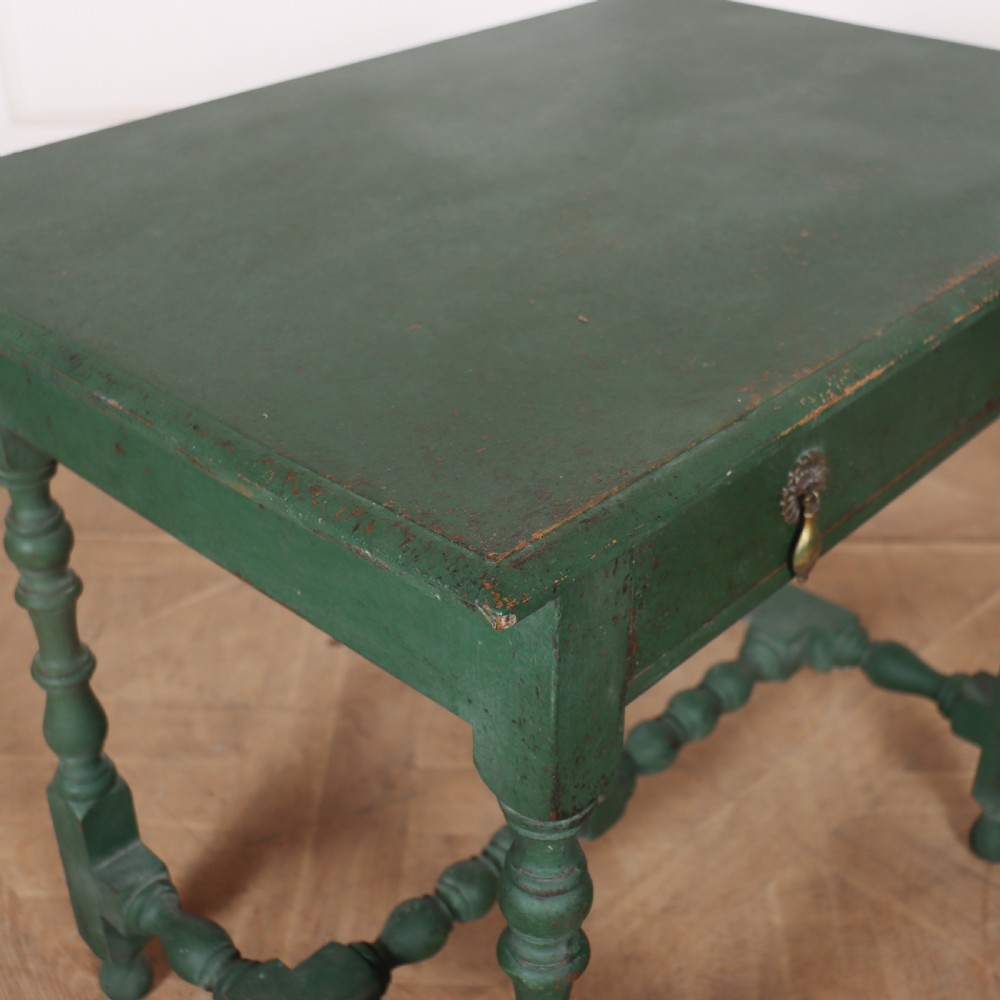 An 18th-century English lamp table featuring a dark green painted surface, single drawer with brass handles, and turned legs with lower stretchers. View VII