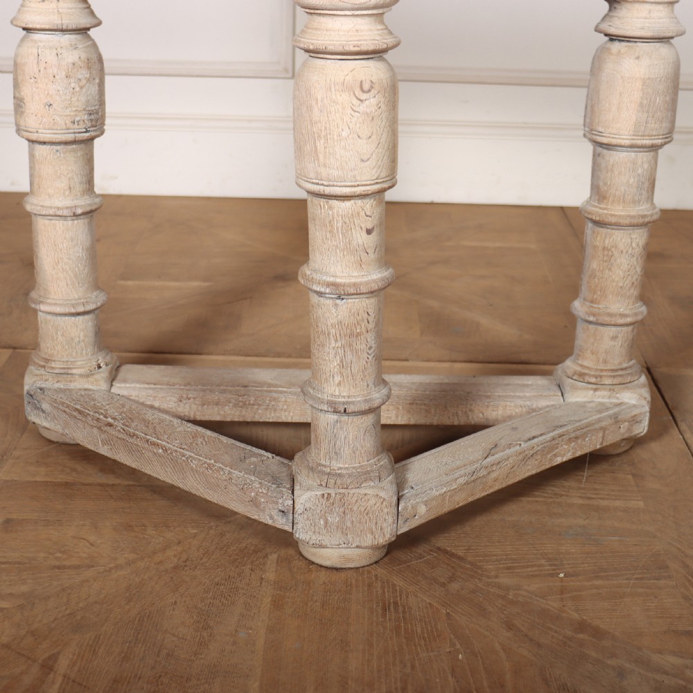 An 18th century Dutch demilune console table made from bleached oak, featuring three heavy turned legs, a scalloped apron, and a triangular low stretcher base. View II