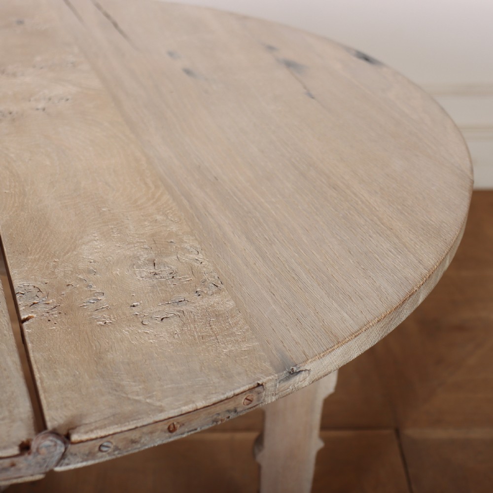 An 18th century Dutch demilune console table made from bleached oak, featuring three heavy turned legs, a scalloped apron, and a triangular low stretcher base. View VII