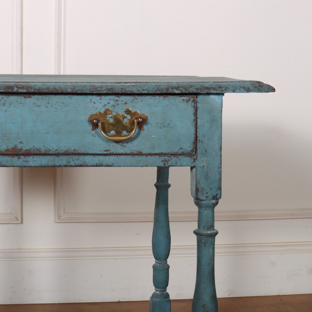 An 18th-century rectangular lamp table featuring a distressed blue painted finish, turned legs, a lower stretcher base, and a single drawer with brass handles. View III