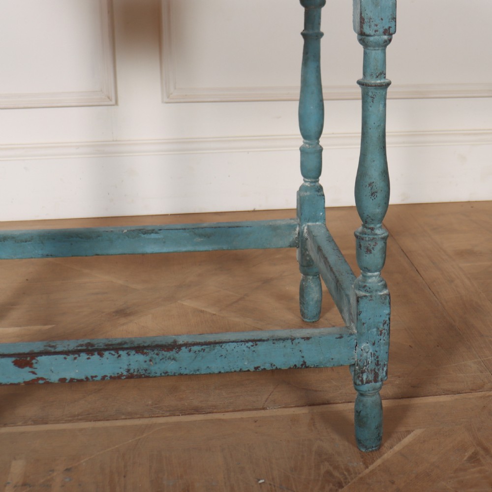 An 18th-century rectangular lamp table featuring a distressed blue painted finish, turned legs, a lower stretcher base, and a single drawer with brass handles. View IV