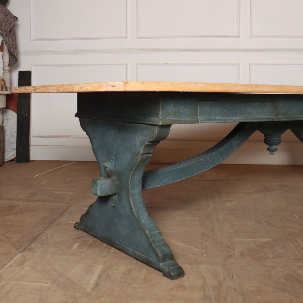 An Italian trestle table featuring a scrubbed natural pine top supported by a dark teal painted timber base with shaped legs and a central stretcher. View II