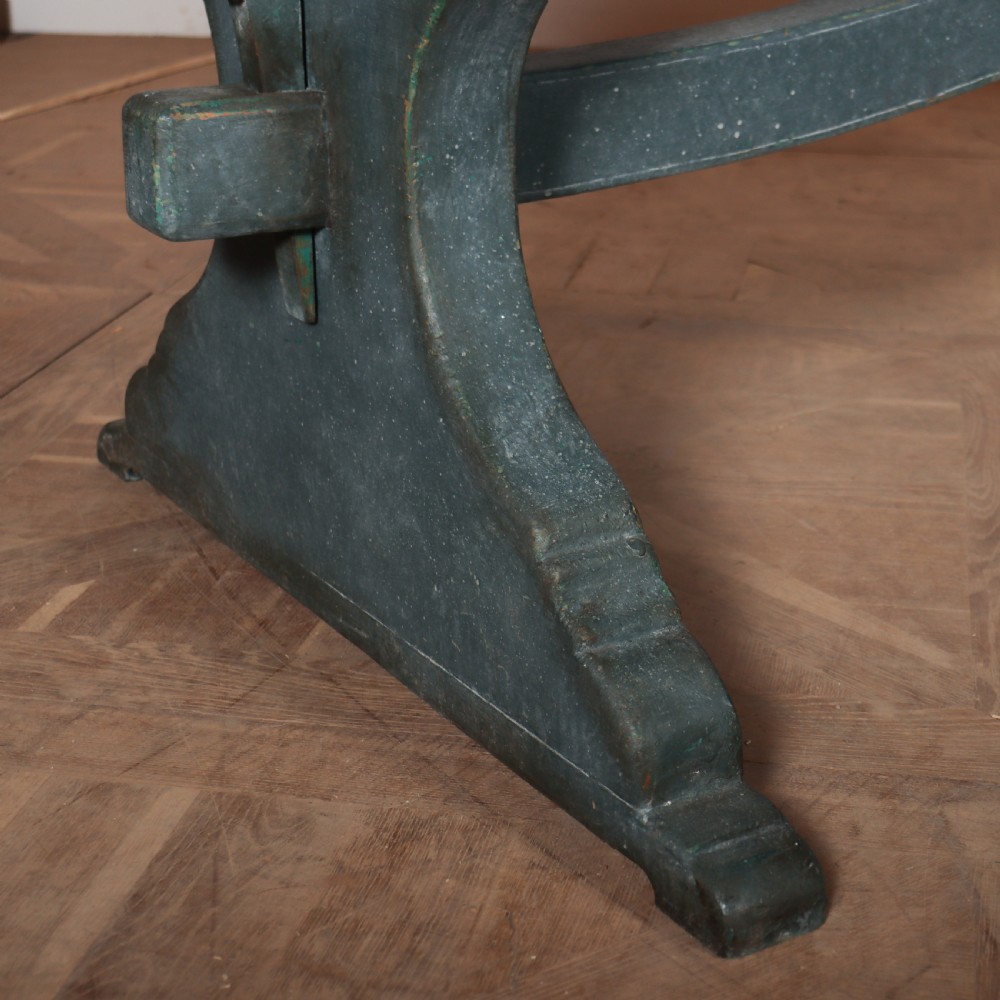An Italian trestle table featuring a scrubbed natural pine top supported by a dark teal painted timber base with shaped legs and a central stretcher. View III