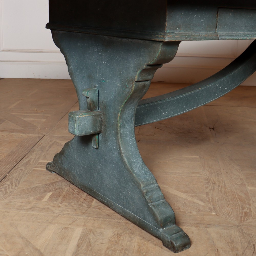 An Italian trestle table featuring a scrubbed natural pine top supported by a dark teal painted timber base with shaped legs and a central stretcher. View IV