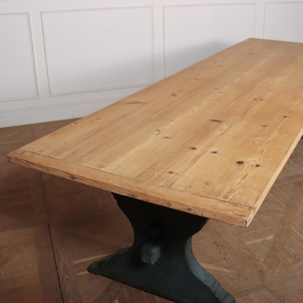 An Italian trestle table featuring a scrubbed natural pine top supported by a dark teal painted timber base with shaped legs and a central stretcher. View V