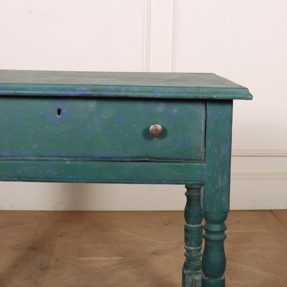 An English side table featuring a weathered teal green painted finish, a single drawer with two round knobs, turned legs, and lower stretchers. View II