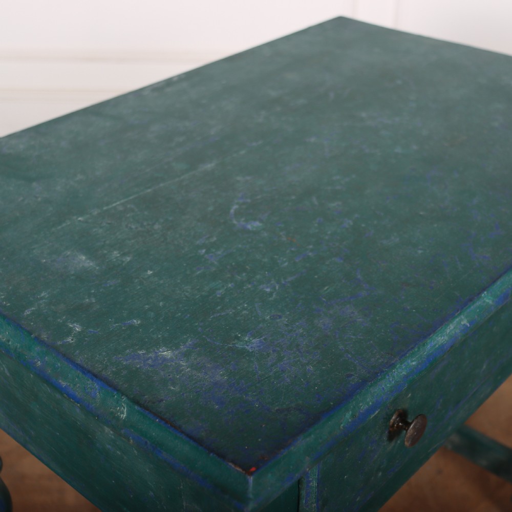 An English side table featuring a weathered teal green painted finish, a single drawer with two round knobs, turned legs, and lower stretchers. View VIII