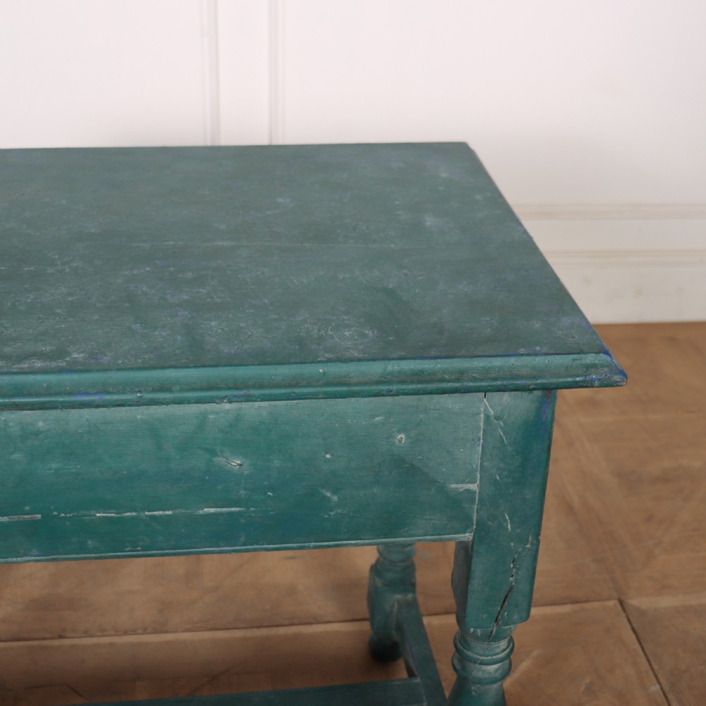 An English side table featuring a weathered teal green painted finish, a single drawer with two round knobs, turned legs, and lower stretchers. View IX
