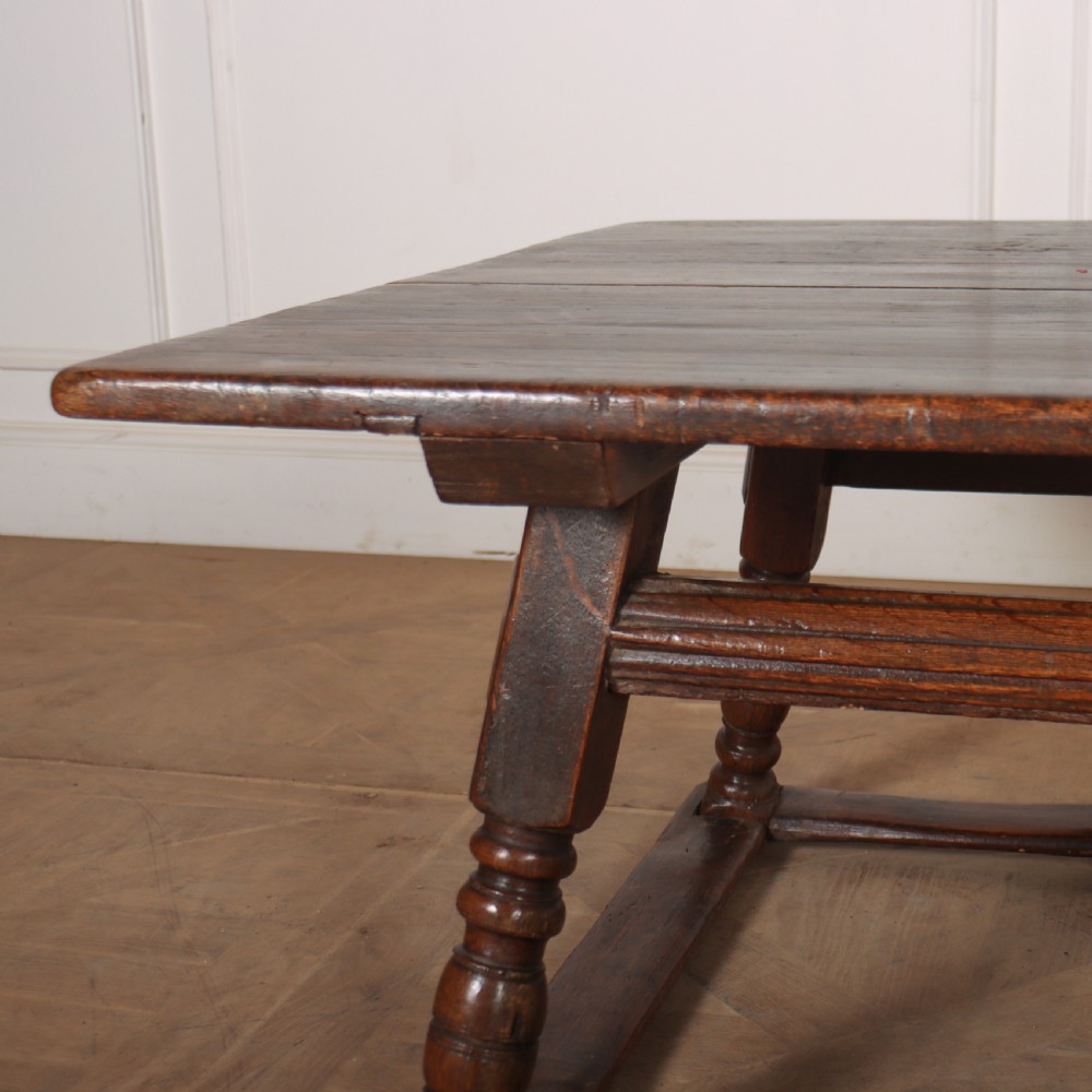 An 18th-century Austrian low table crafted from dark wood with splayed turned legs and a sturdy perimeter stretcher base. View II