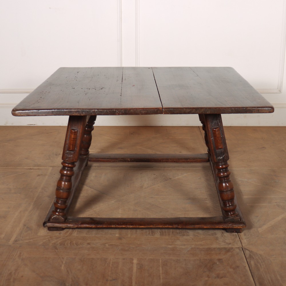 An 18th-century Austrian low table crafted from dark wood with splayed turned legs and a sturdy perimeter stretcher base. View III