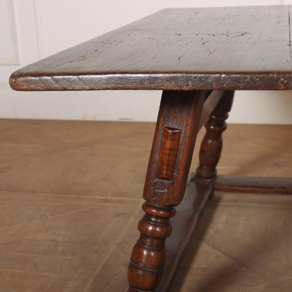 An 18th-century Austrian low table crafted from dark wood with splayed turned legs and a sturdy perimeter stretcher base. View IV