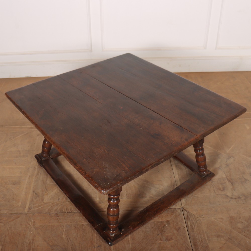 An 18th-century Austrian low table crafted from dark wood with splayed turned legs and a sturdy perimeter stretcher base. View VI
