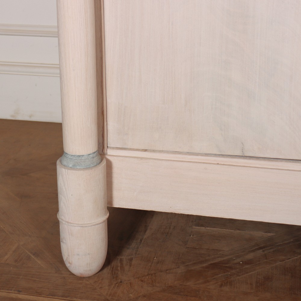 A long French Empire style painted wooden enfilade with four doors, columnar legs, brass escutcheons, and a dark marble top. View III
