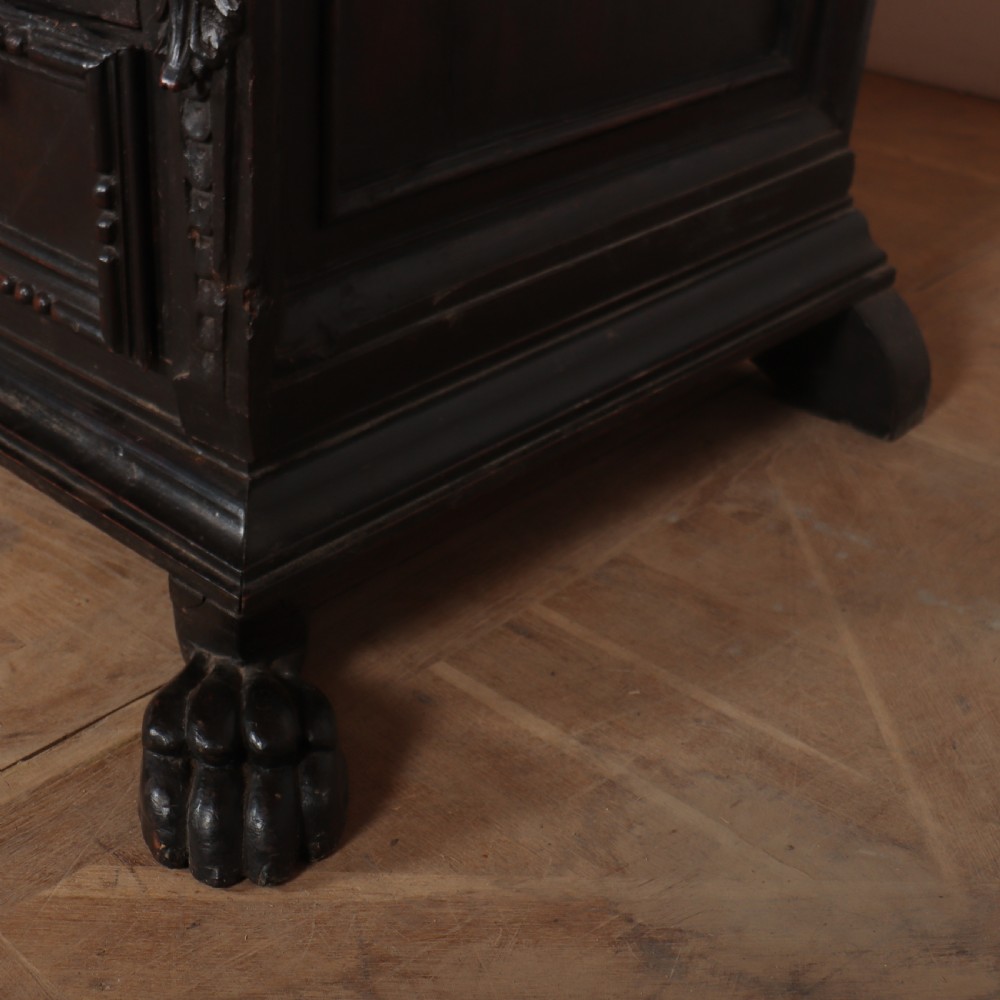 An 18th-century dark walnut Italian commode featuring carved mask pulls, caryatid pilasters, and carved claw feet. View IX
