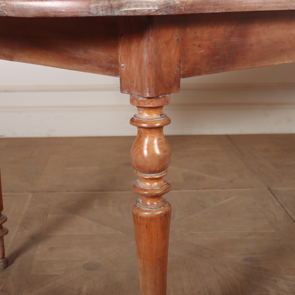 A long wooden French farmhouse dining table featuring rounded D-shaped ends and turned legs. View II
