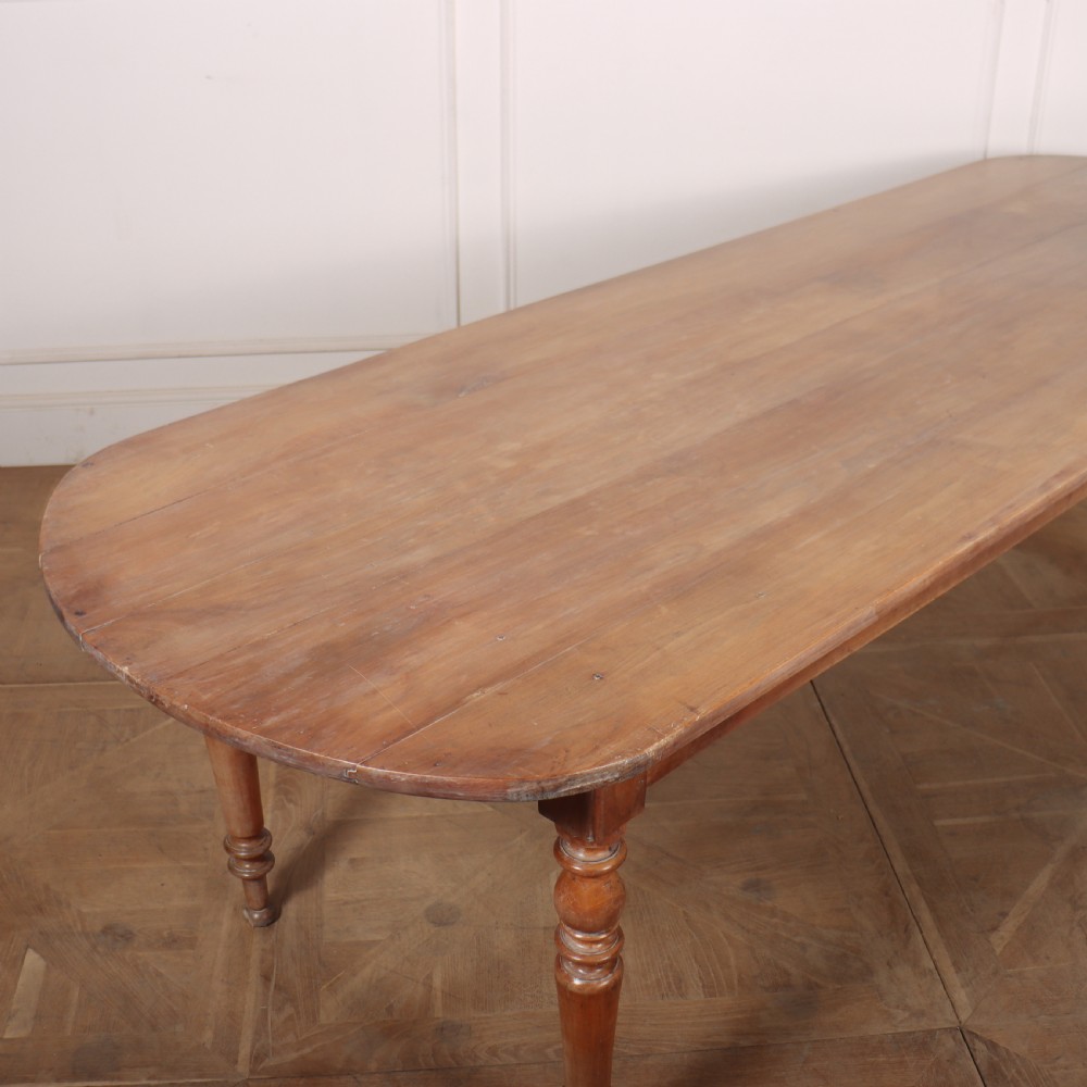 A long wooden French farmhouse dining table featuring rounded D-shaped ends and turned legs. View IV