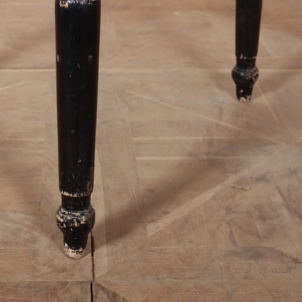 A Welsh pine cricket table featuring a circular scrubbed timber top supported by three turned legs in a distressed black painted finish. View III