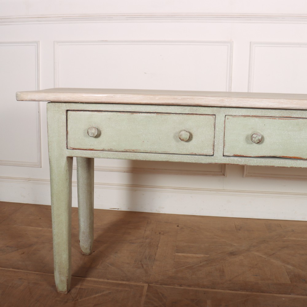 A long narrow wooden console table featuring a pale green painted base, three drawers with wooden turned knobs, and a natural light wood top. View II