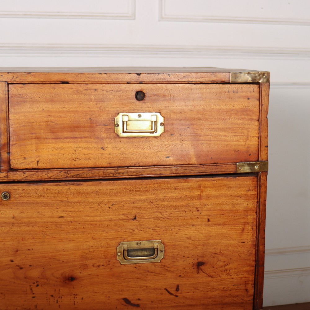 A nineteenth-century two-part military campaign chest of drawers in warm brown timber featuring flush brass handles and corner straps. View II