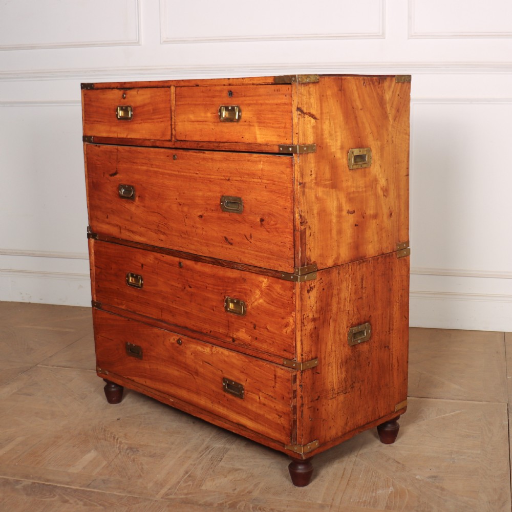 A nineteenth-century two-part military campaign chest of drawers in warm brown timber featuring flush brass handles and corner straps. View V