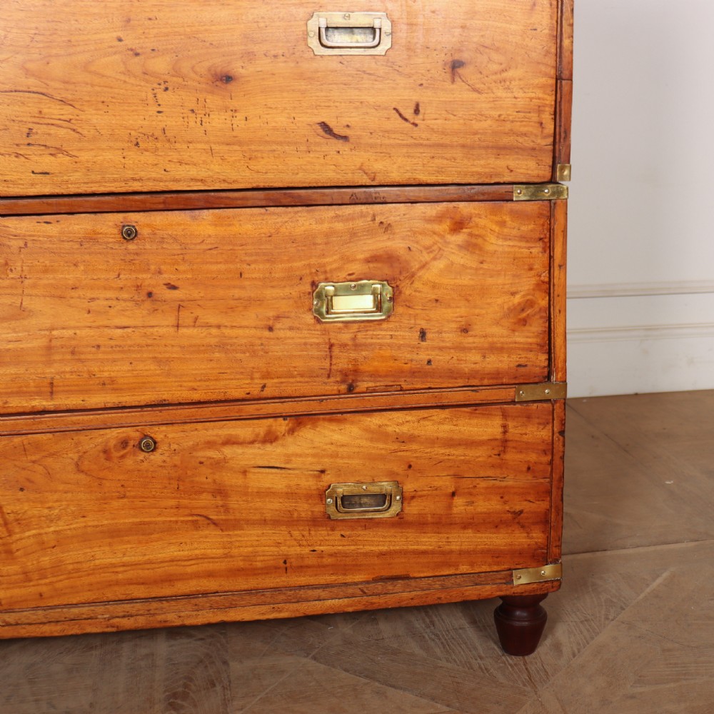 A nineteenth-century two-part military campaign chest of drawers in warm brown timber featuring flush brass handles and corner straps. View VI