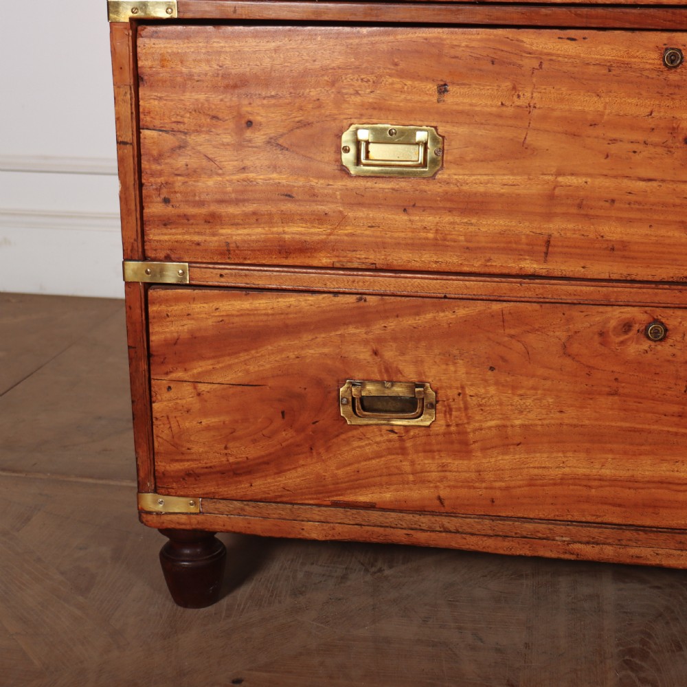 A nineteenth-century two-part military campaign chest of drawers in warm brown timber featuring flush brass handles and corner straps. View VII