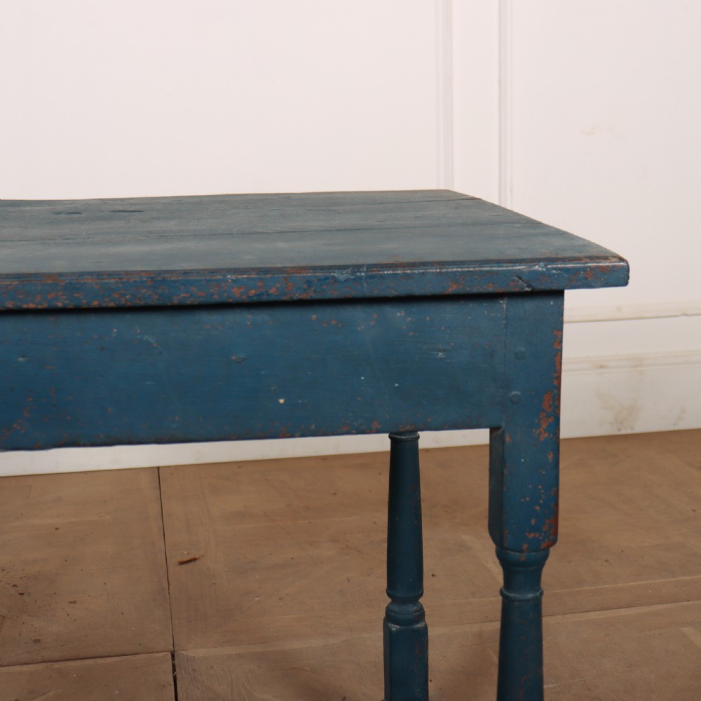 An 18th-century rectangular wooden side table featuring turned legs, a low box stretcher, and a distressed blue painted finish. View V