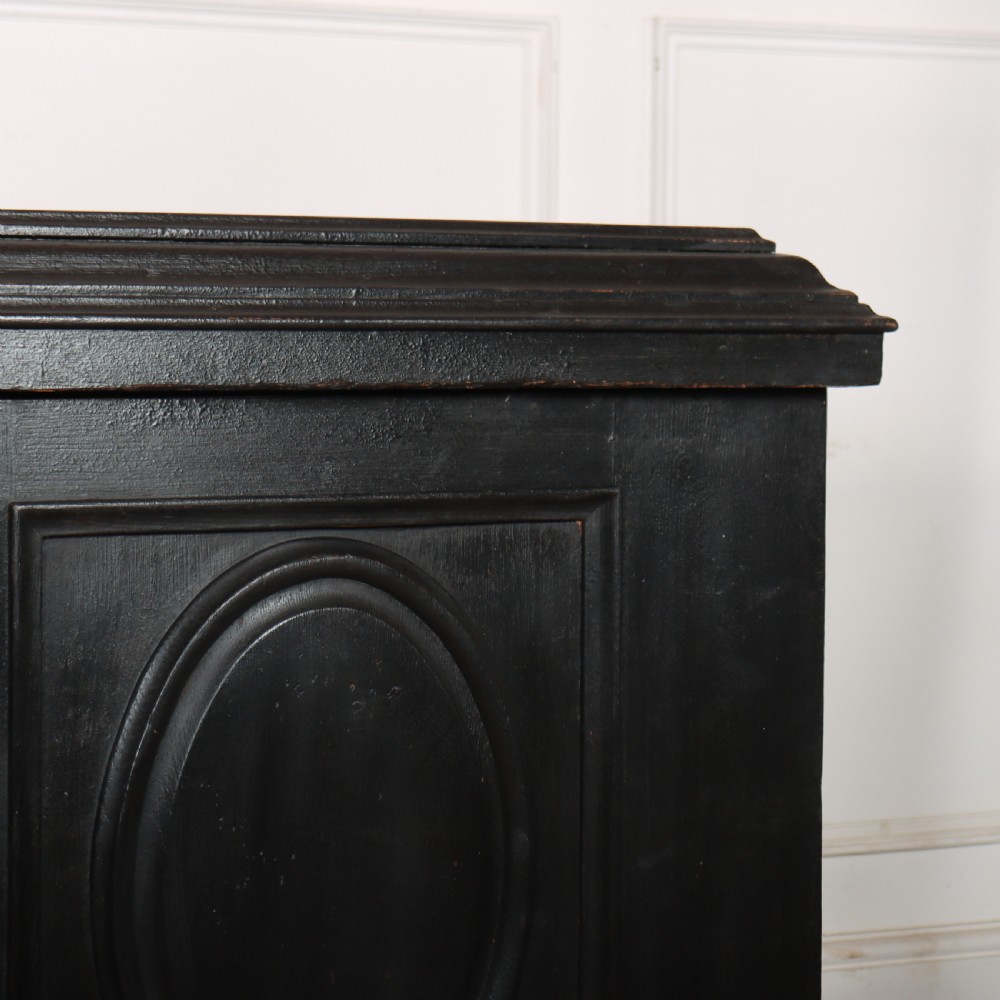 A low black painted wooden credenza featuring three panelled doors with oval mouldings and resting on carved paw feet. View IV