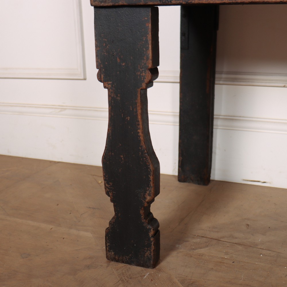 An 18th-century dark painted wooden kitchen dresser base featuring four drawers with brass handles beneath an open wall-mounted plate rack. View VI