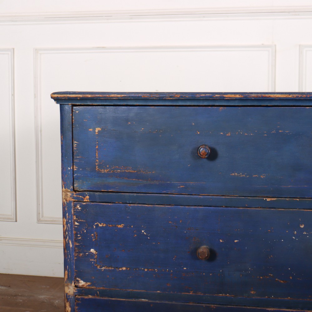 A three-drawer wooden chest of drawers featuring a weathered blue painted finish, small turned knobs, and square tapered feet. View II