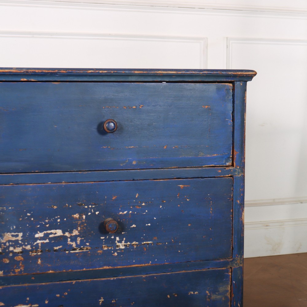 A three-drawer wooden chest of drawers featuring a weathered blue painted finish, small turned knobs, and square tapered feet. View III