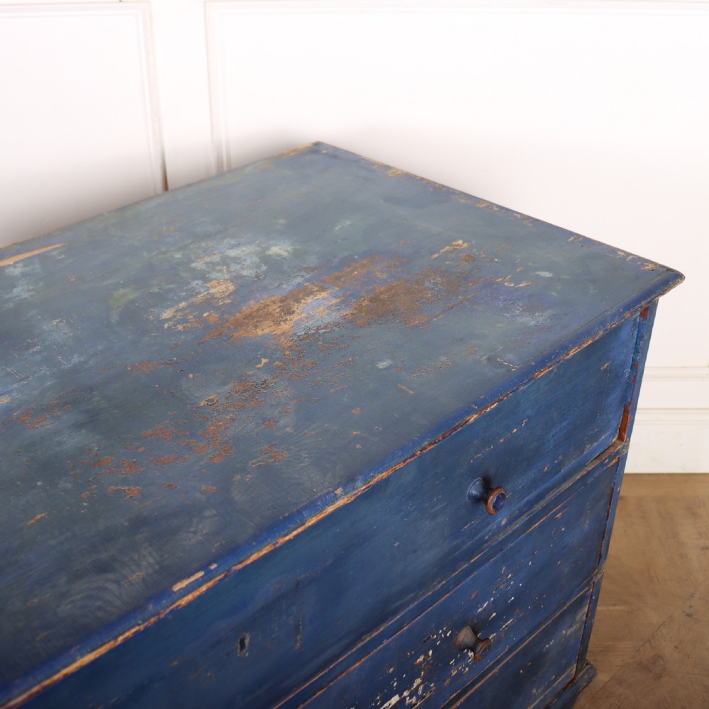 A three-drawer wooden chest of drawers featuring a weathered blue painted finish, small turned knobs, and square tapered feet. View IX