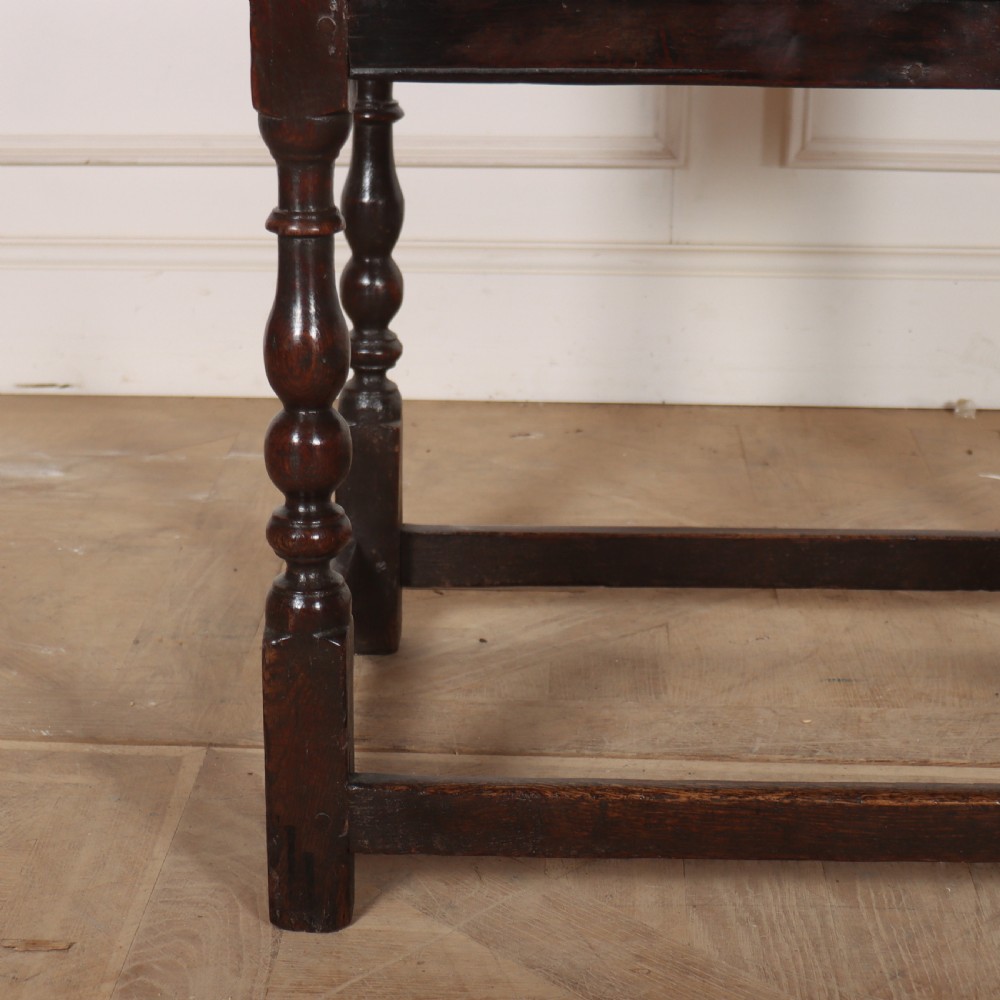 An 18th-century dark oak lamp table featuring turned legs, a single drawer with a brass handle, and low stretchers. View II