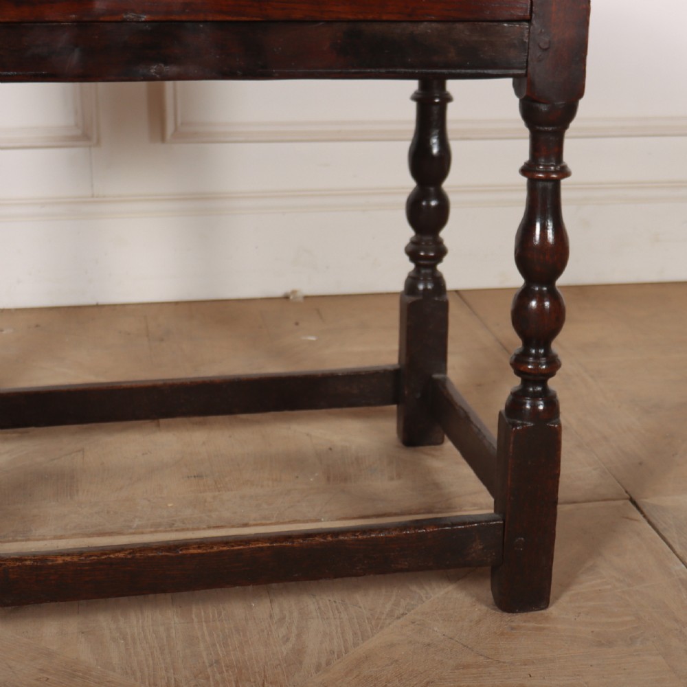 An 18th-century dark oak lamp table featuring turned legs, a single drawer with a brass handle, and low stretchers. View IV