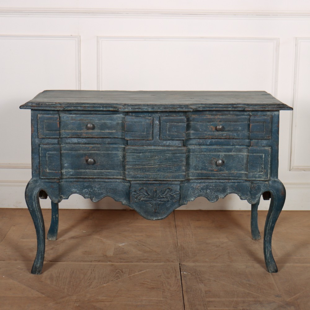 An 18th-century Portuguese serpentine commode featuring a blue painted finish, cabriole legs, and a carved apron.