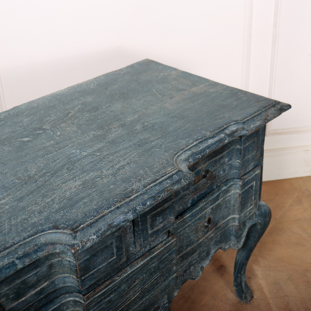 An 18th-century Portuguese serpentine commode featuring a blue painted finish, cabriole legs, and a carved apron. View IX