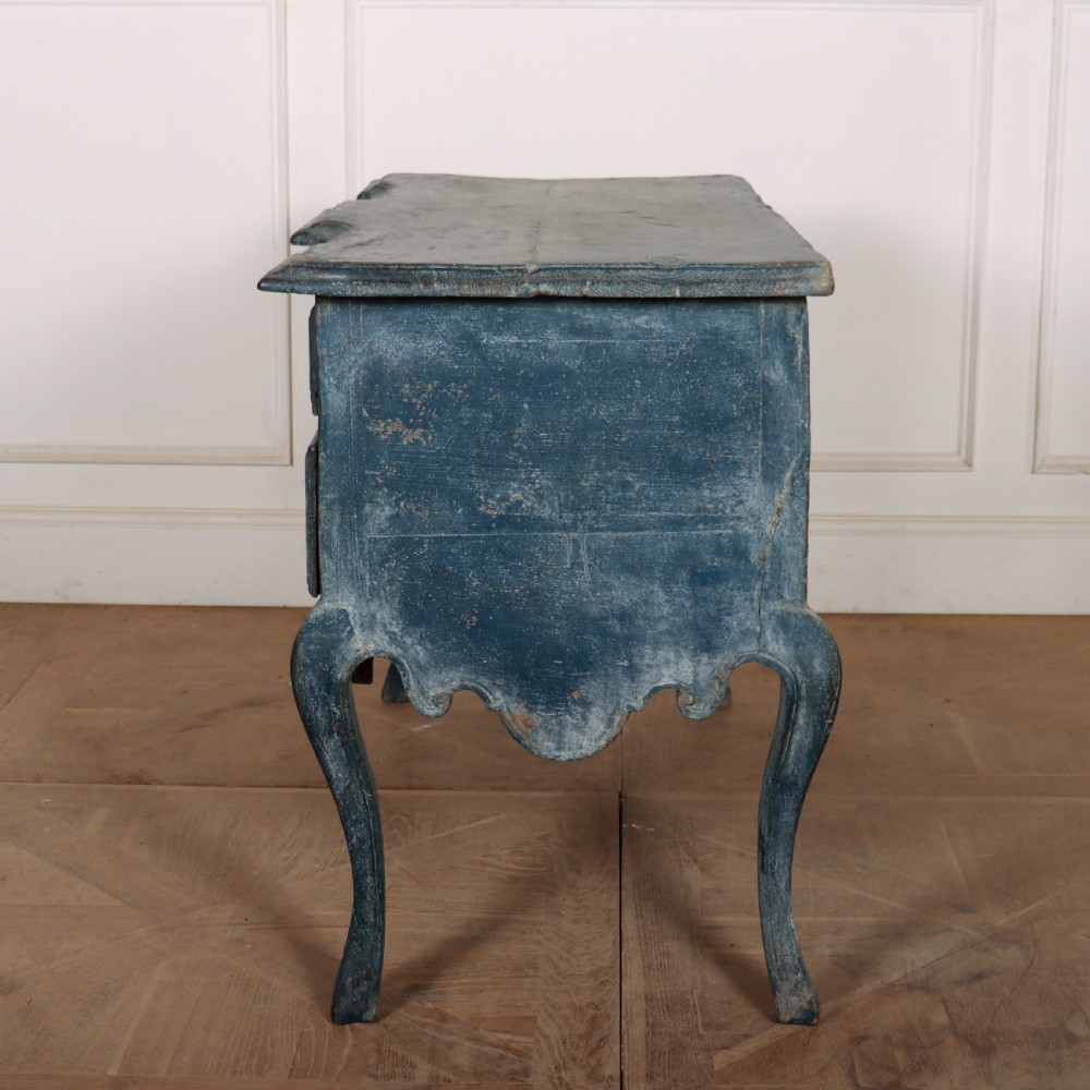 An 18th-century Portuguese serpentine commode featuring a blue painted finish, cabriole legs, and a carved apron. View X