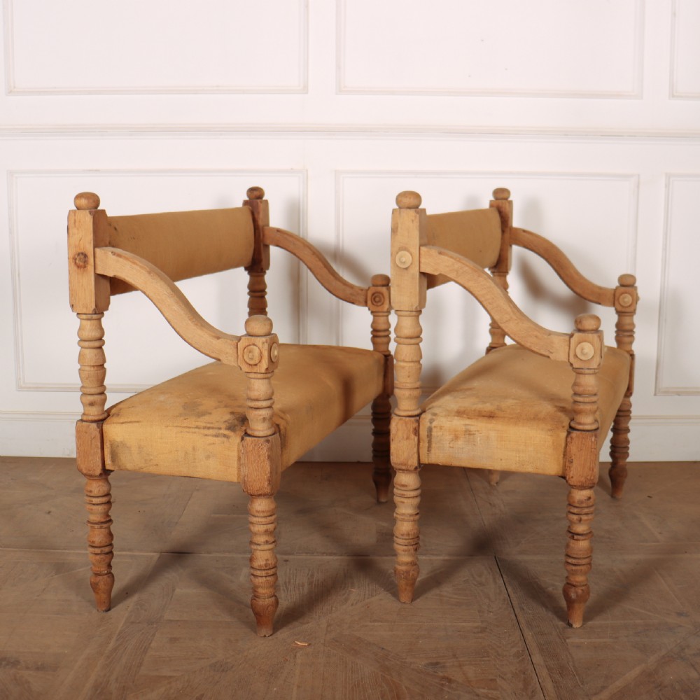 Pair of French bleached oak settles with turned legs, carved rosette details, and neutral canvas upholstery. View IV