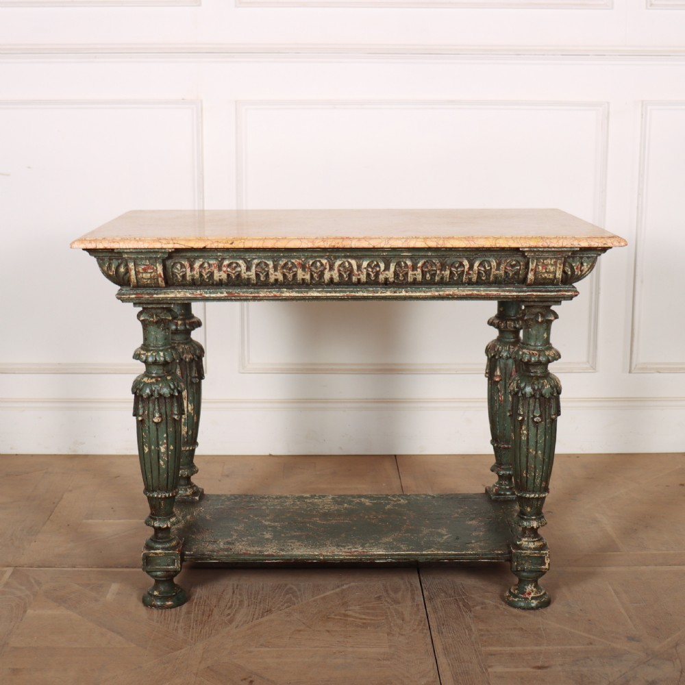 A French pastry table featuring a polished light pink marble top supported by a carved distressed green painted wood base with an undertier shelf.