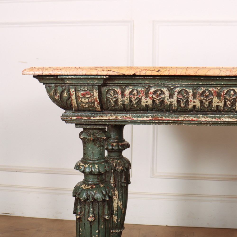 A French pastry table featuring a polished light pink marble top supported by a carved distressed green painted wood base with an undertier shelf. View II