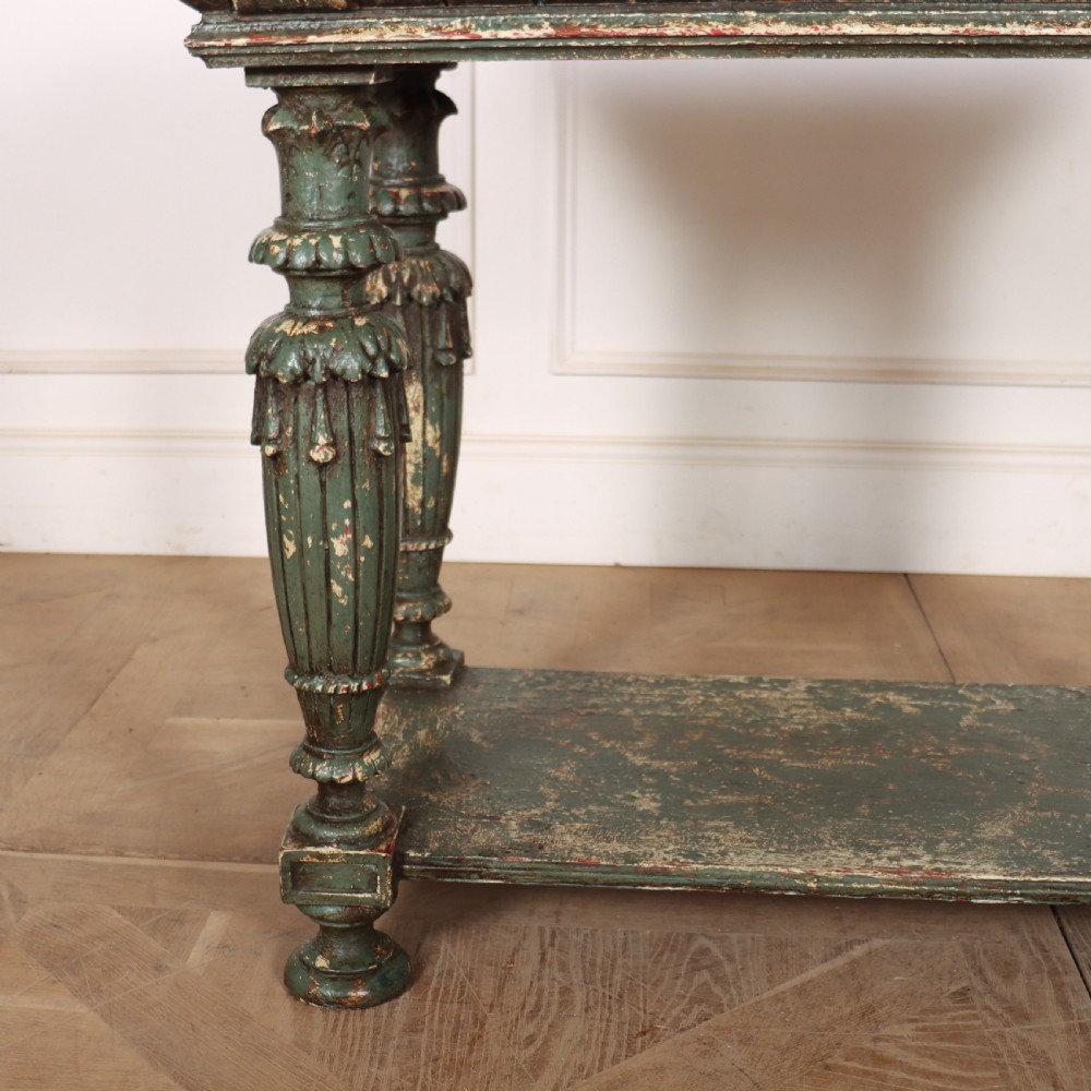 A French pastry table featuring a polished light pink marble top supported by a carved distressed green painted wood base with an undertier shelf. View III