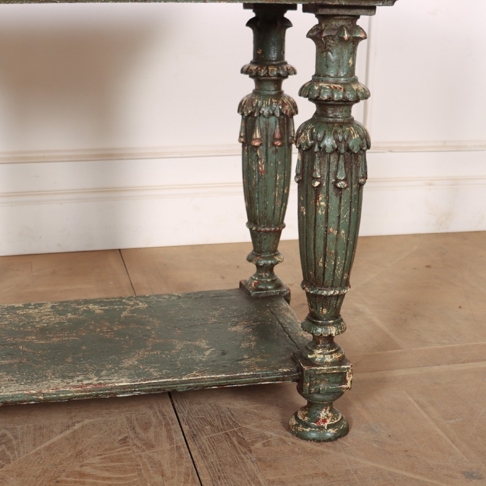 A French pastry table featuring a polished light pink marble top supported by a carved distressed green painted wood base with an undertier shelf. View V