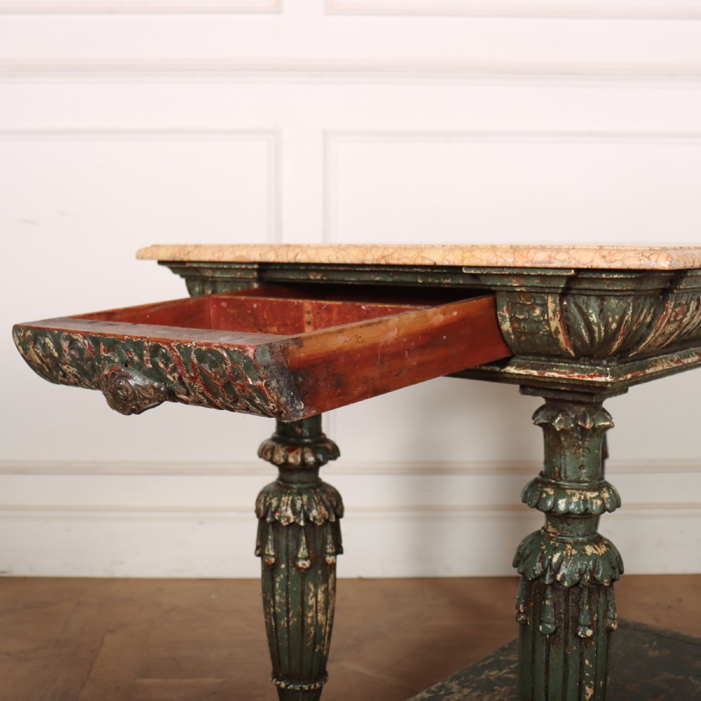 A French pastry table featuring a polished light pink marble top supported by a carved distressed green painted wood base with an undertier shelf. View VII