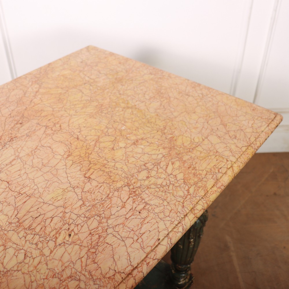 A French pastry table featuring a polished light pink marble top supported by a carved distressed green painted wood base with an undertier shelf. View IX