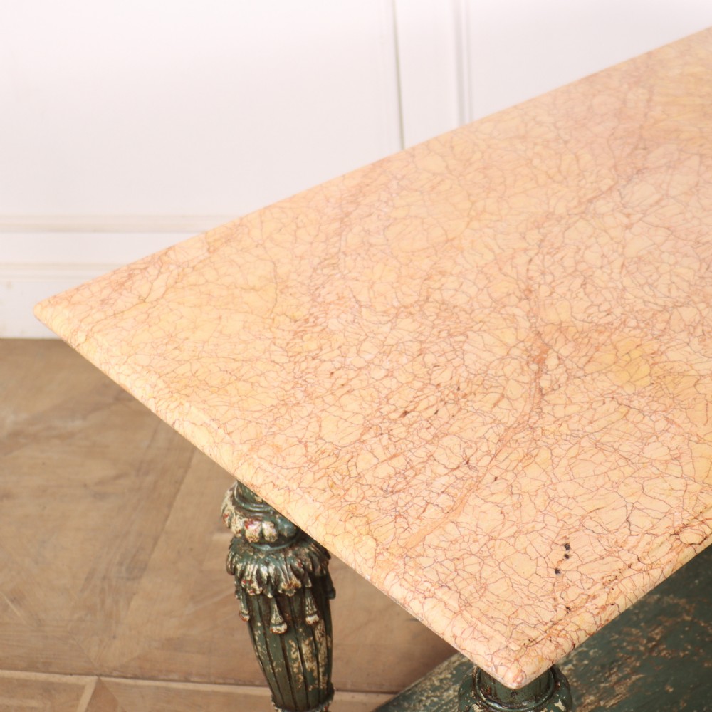 A French pastry table featuring a polished light pink marble top supported by a carved distressed green painted wood base with an undertier shelf. View X