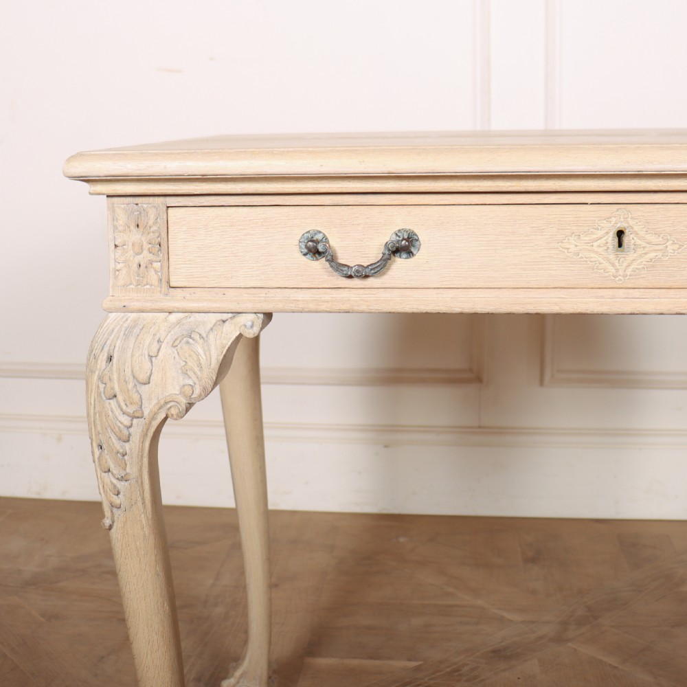 A bleached oak lamp table featuring carved cabriole legs with claw-and-ball feet, acanthus knee carvings, and a single drawer with twin brass drop handles. View II