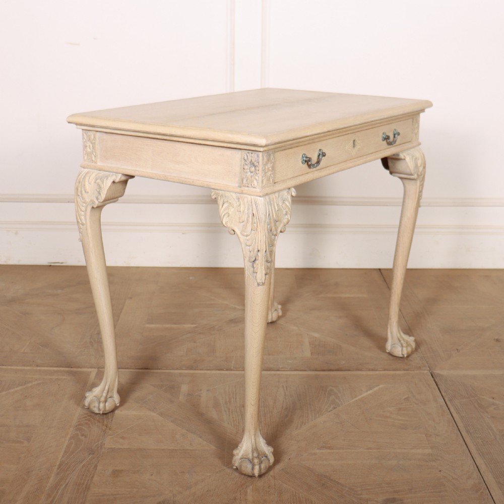 A bleached oak lamp table featuring carved cabriole legs with claw-and-ball feet, acanthus knee carvings, and a single drawer with twin brass drop handles. View III