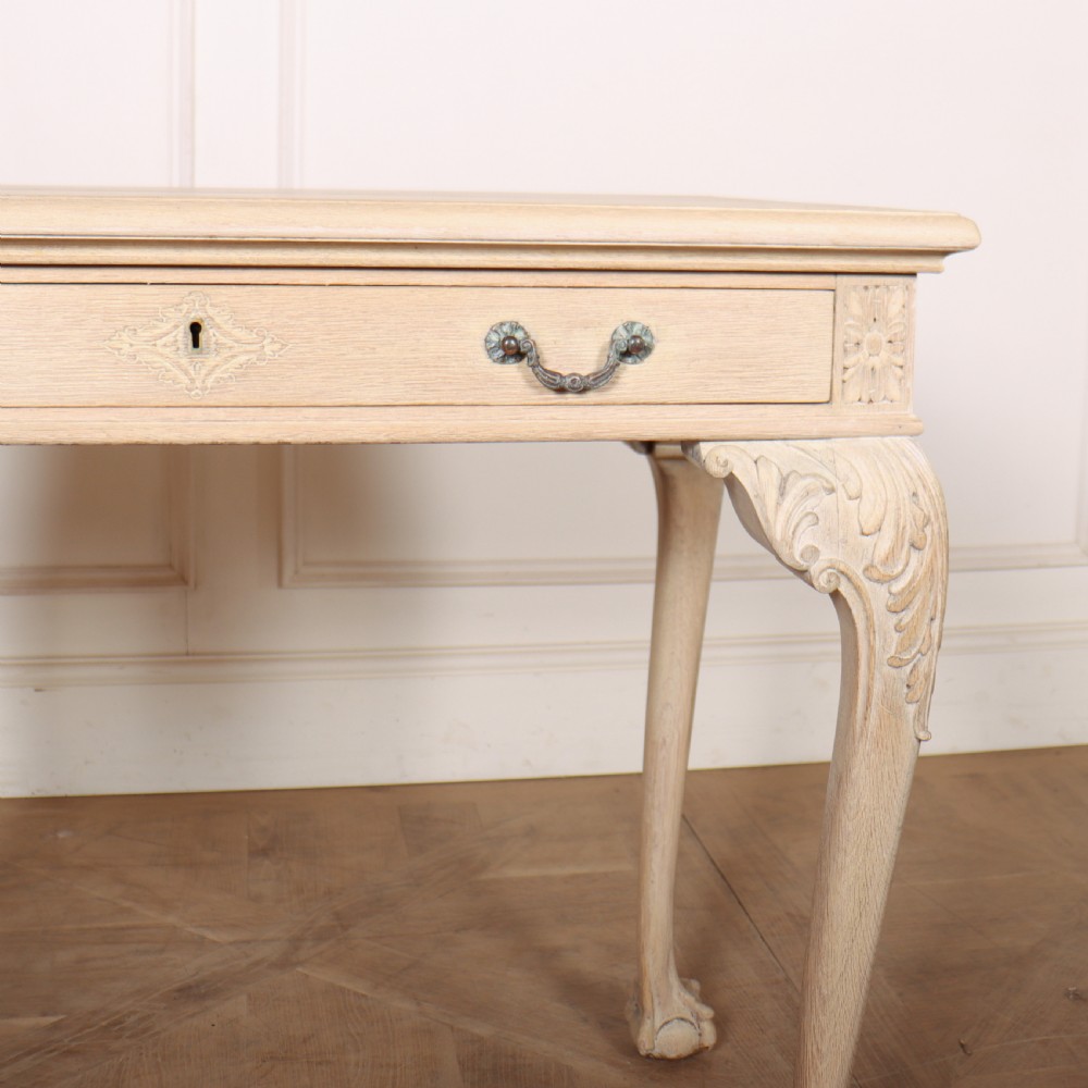 A bleached oak lamp table featuring carved cabriole legs with claw-and-ball feet, acanthus knee carvings, and a single drawer with twin brass drop handles. View IV