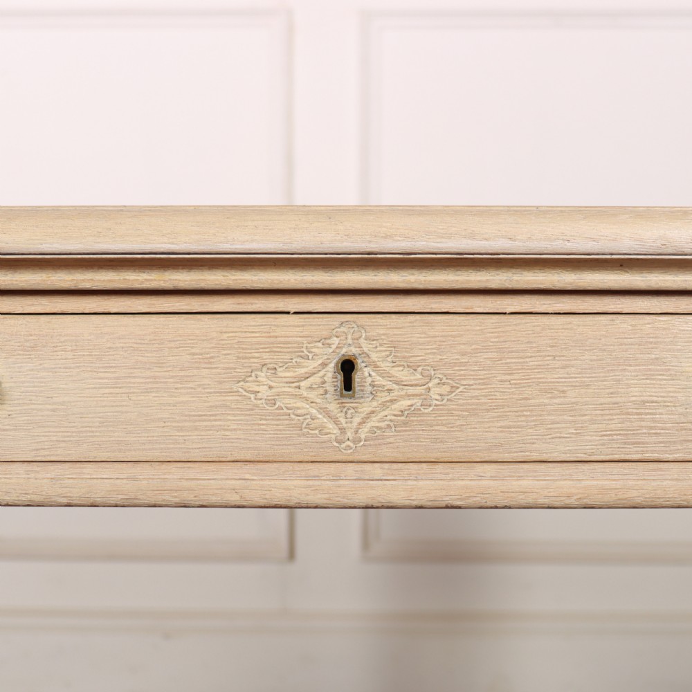 A bleached oak lamp table featuring carved cabriole legs with claw-and-ball feet, acanthus knee carvings, and a single drawer with twin brass drop handles. View VII