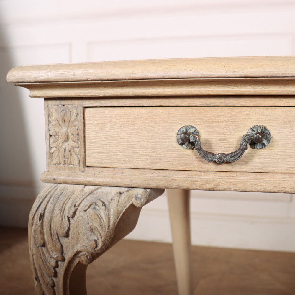 A bleached oak lamp table featuring carved cabriole legs with claw-and-ball feet, acanthus knee carvings, and a single drawer with twin brass drop handles. View VIII